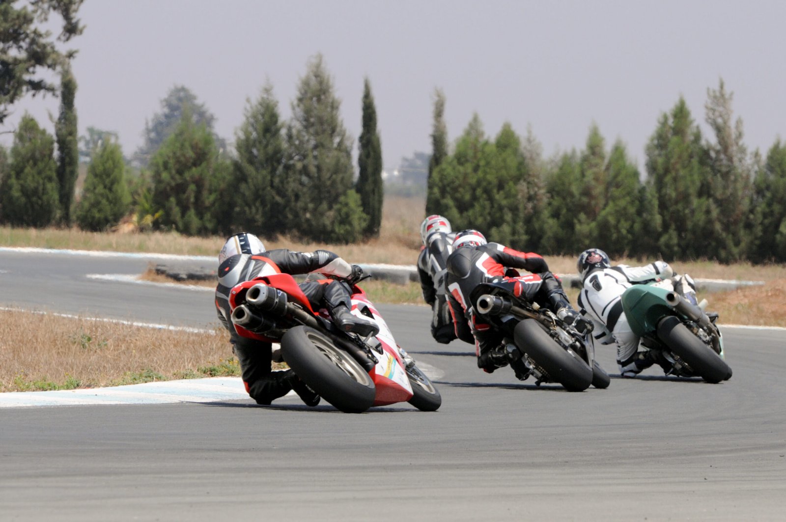 Motorcycle racers displaying high-visibility racing numbers and graphics